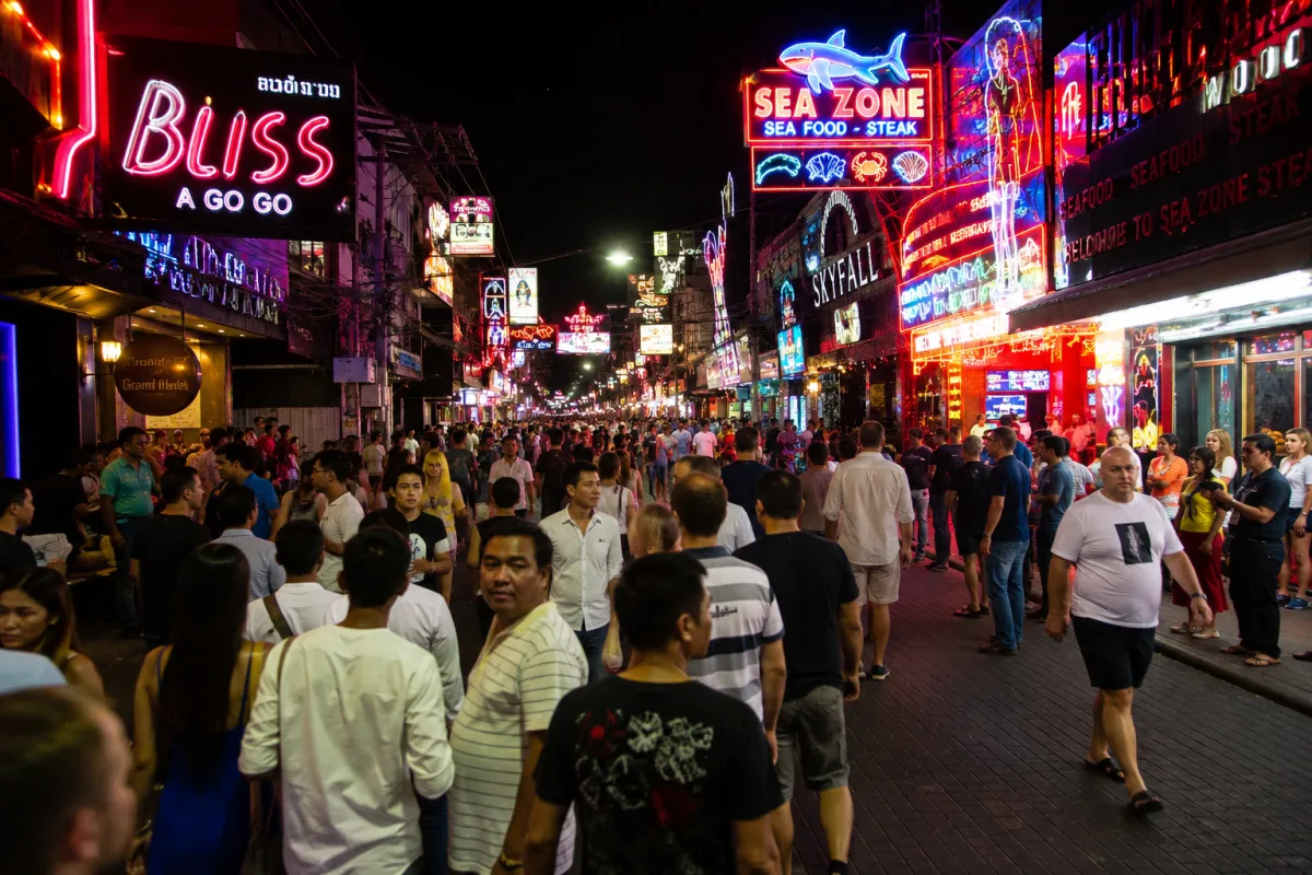 Busy nightlife street in Pattaya with neon lights in the evening (photo)