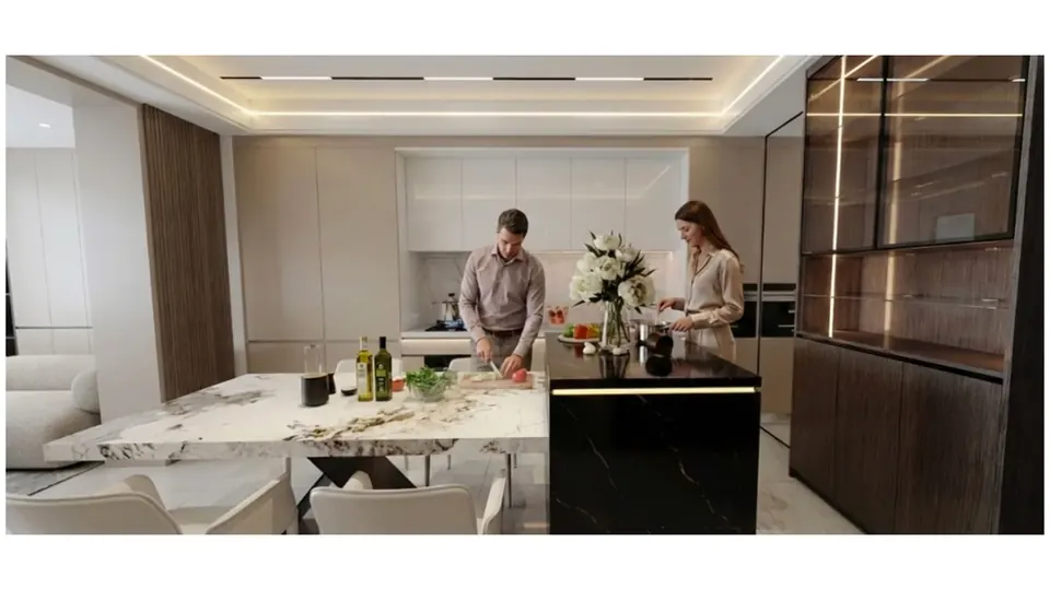 Modern luxury kitchen with a marble cooking island and dining area in a residence at Sea Sky by Sands in Pattaya