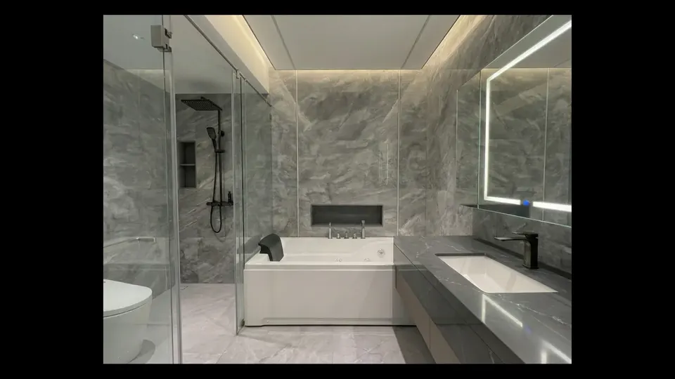 Modern marble bathroom with bathtub, rain shower and LED mirror at the luxury project Sea Sky by Sands in Pattaya